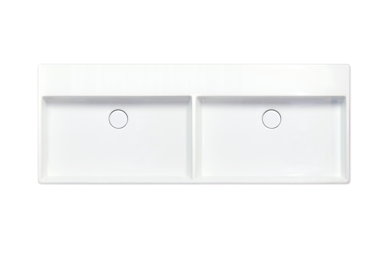 Rechteckiges weißes Doppelwaschbecken mit zwei getrennten Becken und zentralen runden Abflusslöchern, von oben gesehen vor einem schlichten weißen Hintergrund.